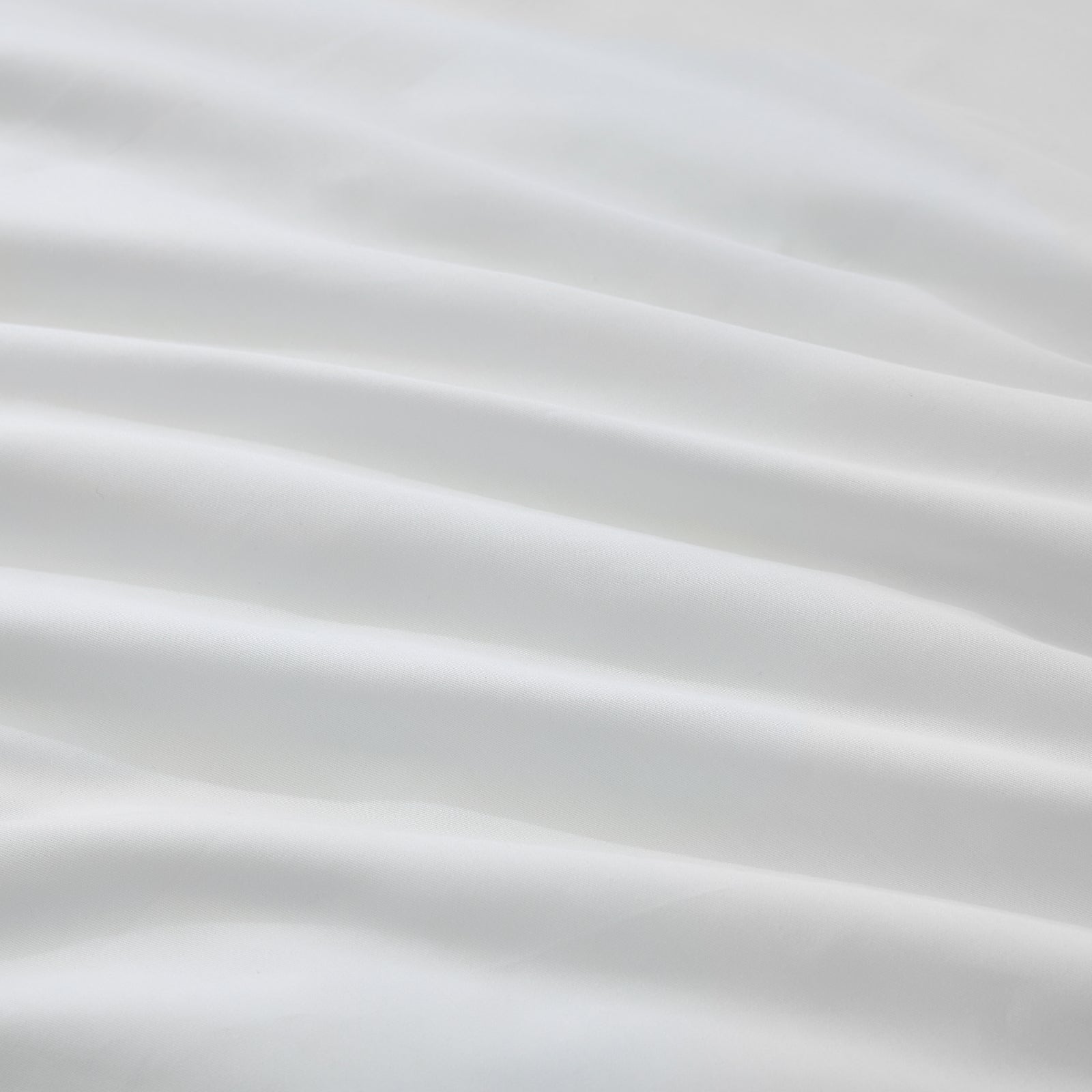 Litanika 100% cotton percale duvet cover set in crisp white bedding with a smooth, tightly woven fabric finish.