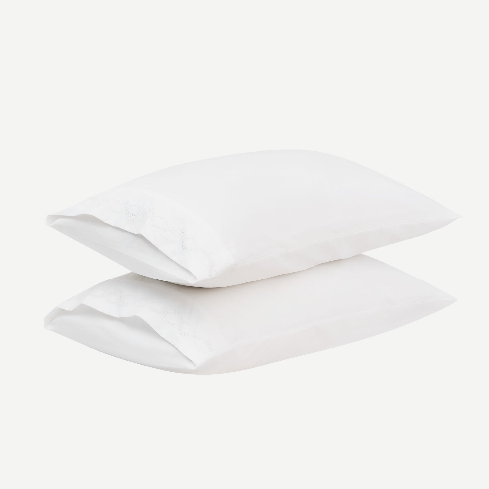 Set of crisp percale organic cotton pillowcases in white, showcasing smooth, breathable bedding from Litanika.