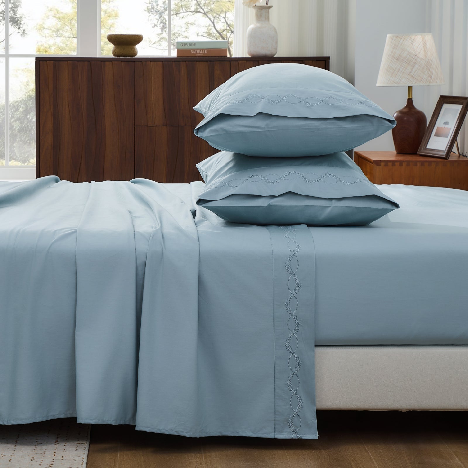 Set of crisp white organic cotton pillowcases from Litanika, showcasing smooth percale bedding fabric.