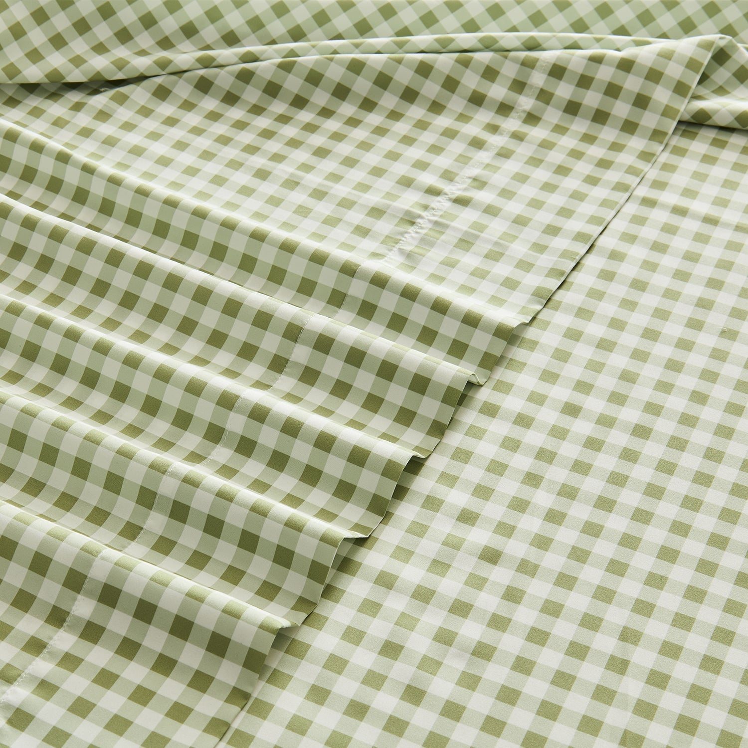 Litanika farmhouse gingham ruffle 4-piece bedding sheet set with gingham pattern and ruffle accents on a bed.