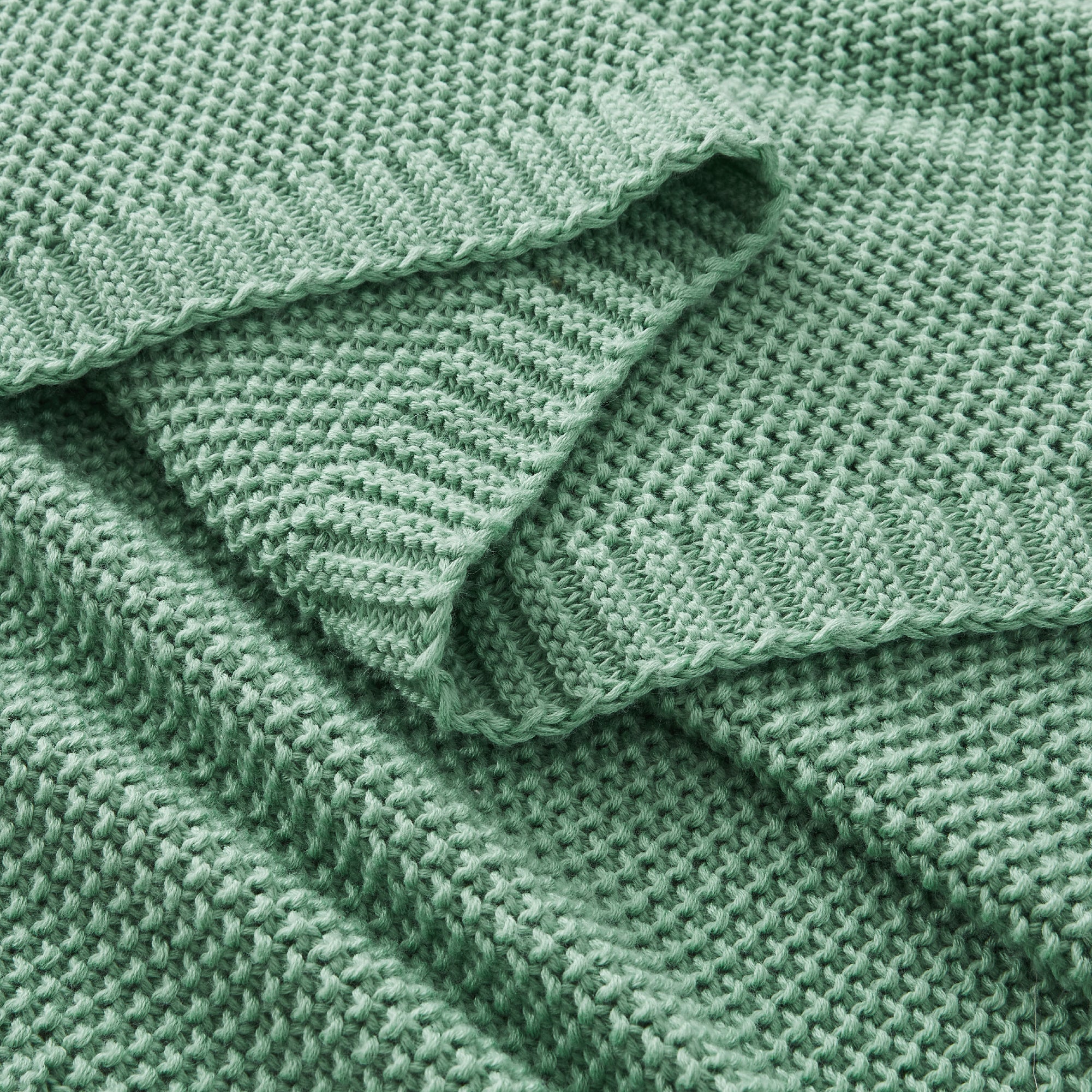 Litanika soft cozy cable knit throw blanket in neutral color, ideal for bedding and adding warmth and comfort to a bedroom.