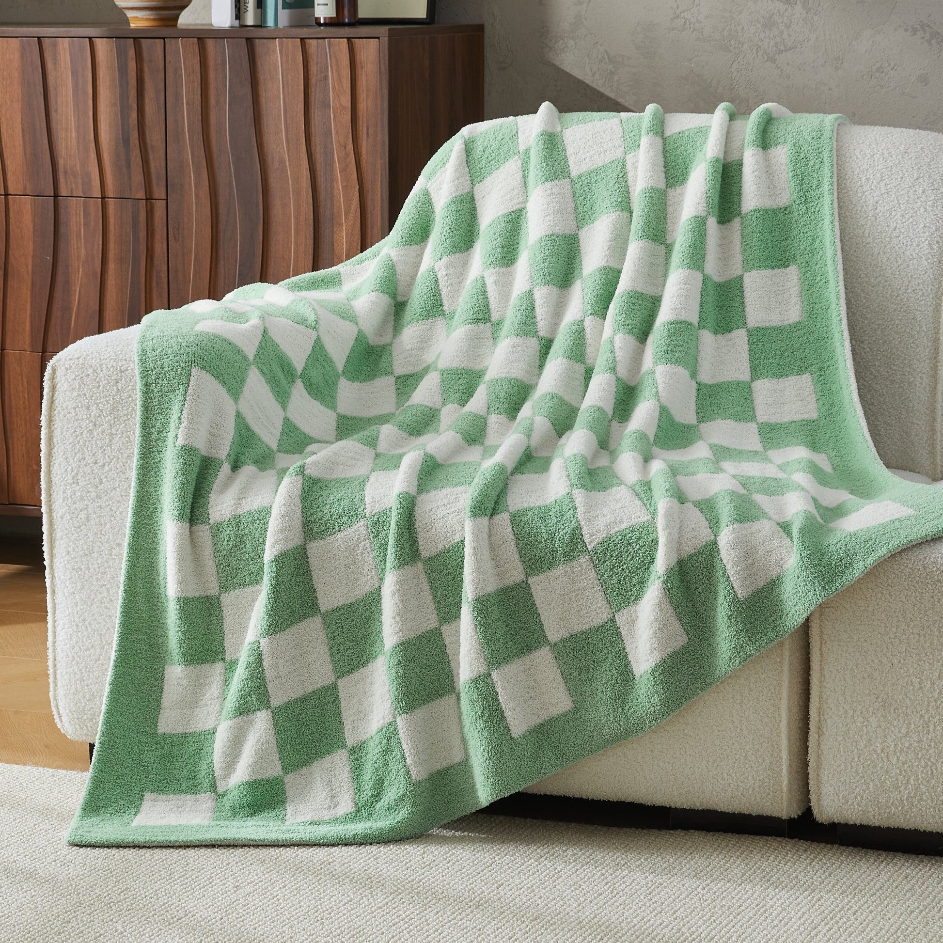 Litanika soft knit checkered throw blanket draped over a bed, showcasing cozy bedding with a classic checkered pattern.