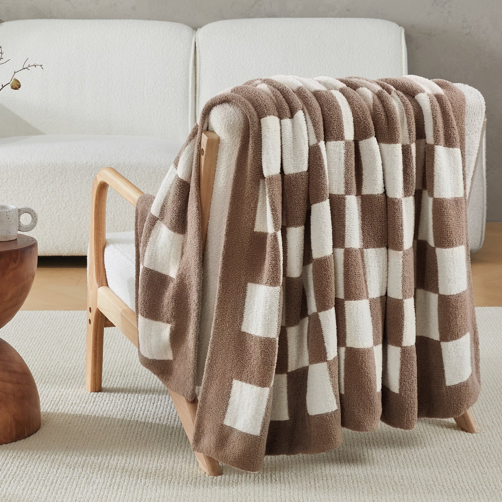Litanika soft knit checkered throw blanket draped over a bed, cozy bedding accessory with a classic checkered pattern.