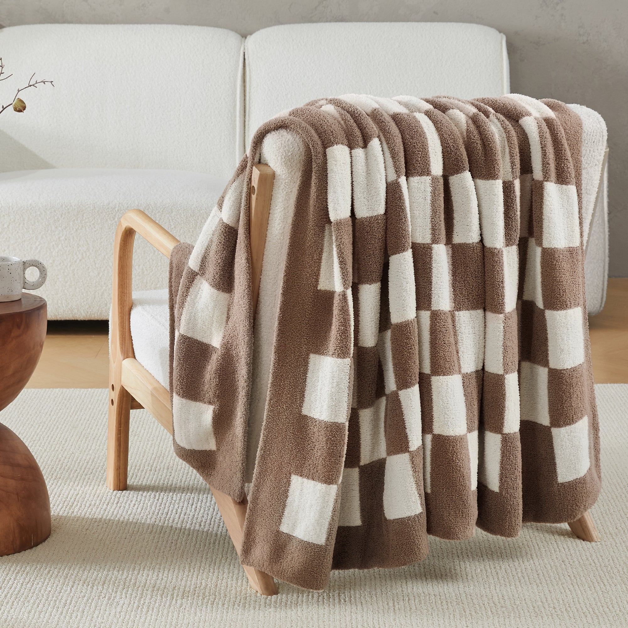 Litanika soft knit checkered throw blanket draped over a bed, cozy bedding accessory with a classic checkered pattern.