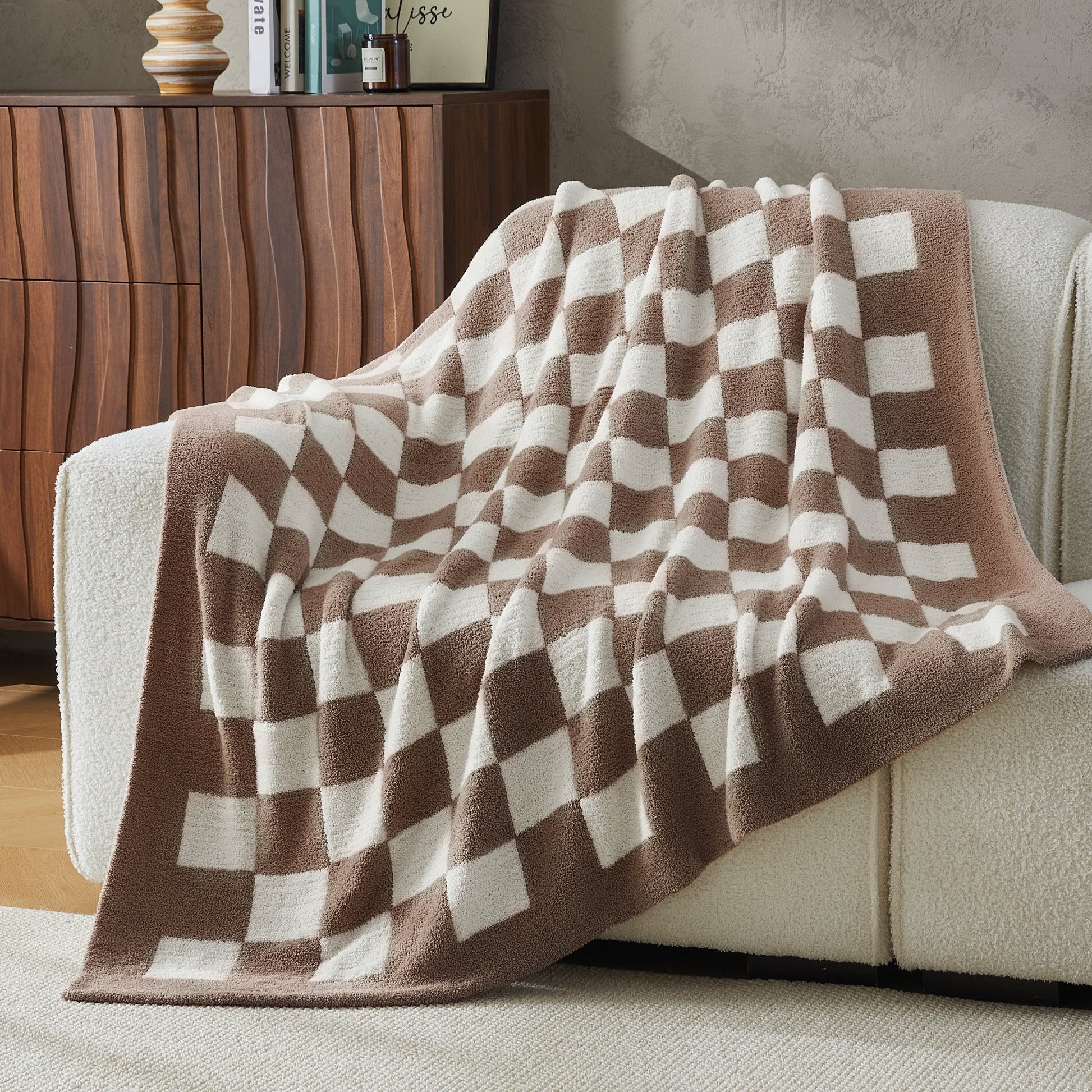 Litanika soft knit checkered throw blanket spread over bed, cozy bedding accessory with a classic pattern and soft texture.