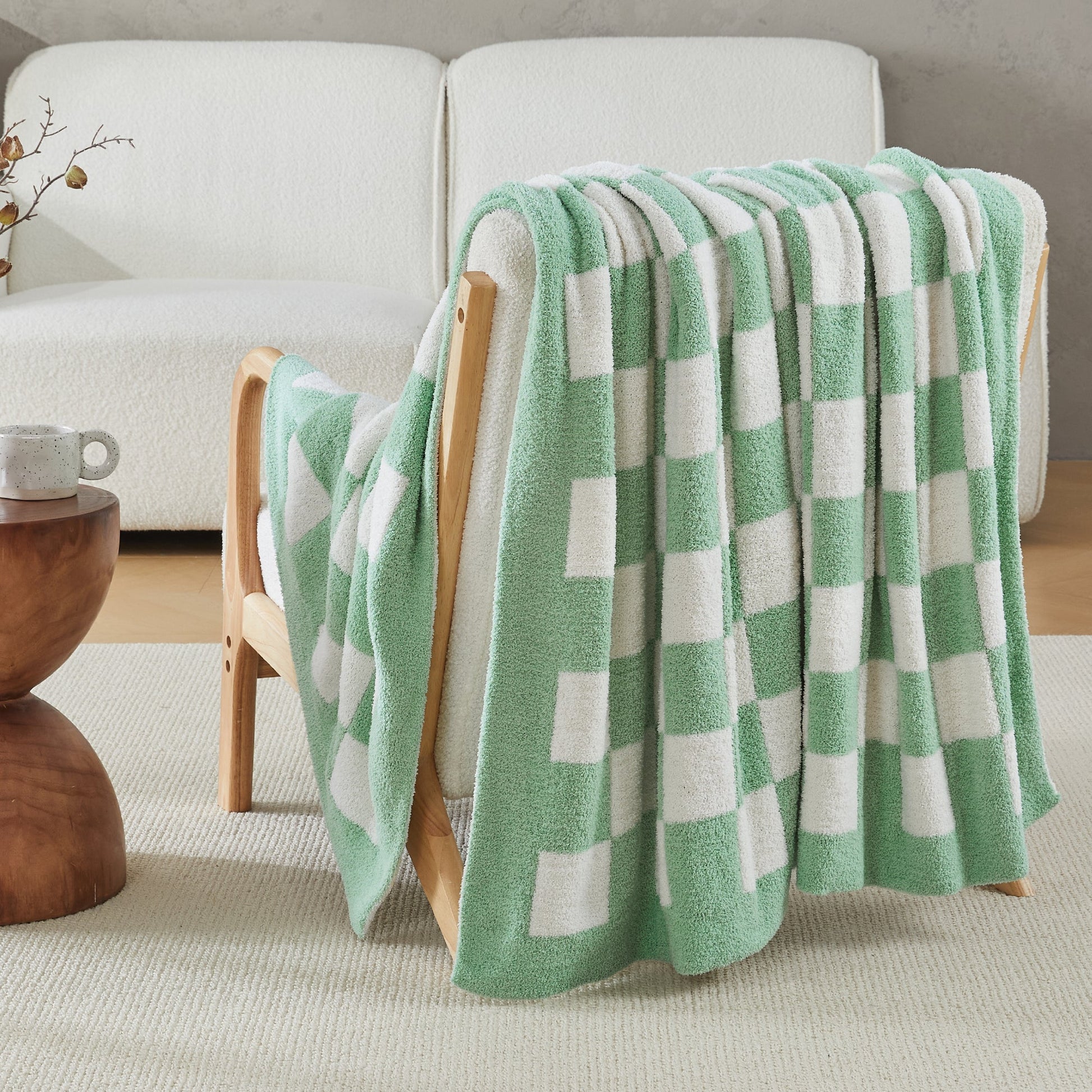Litanika soft knit checkered throw blanket draped over a bed, showcasing cozy bedding with a classic checkered pattern.