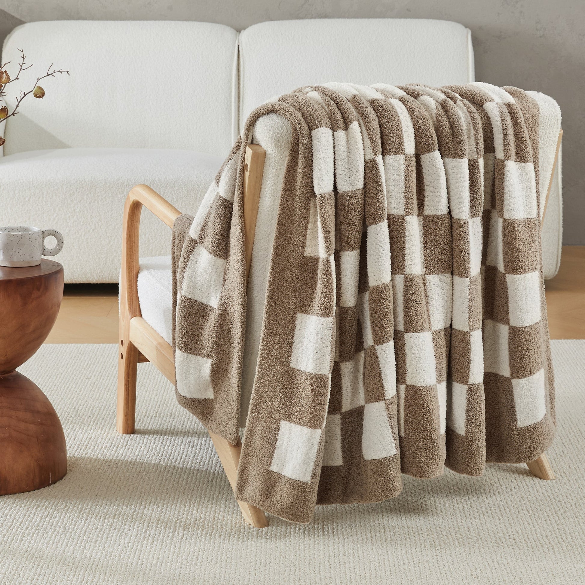 Litanika soft knit checkered throw blanket spread on a bed, showcasing cozy, lightweight bedding with a classic checkered pattern.