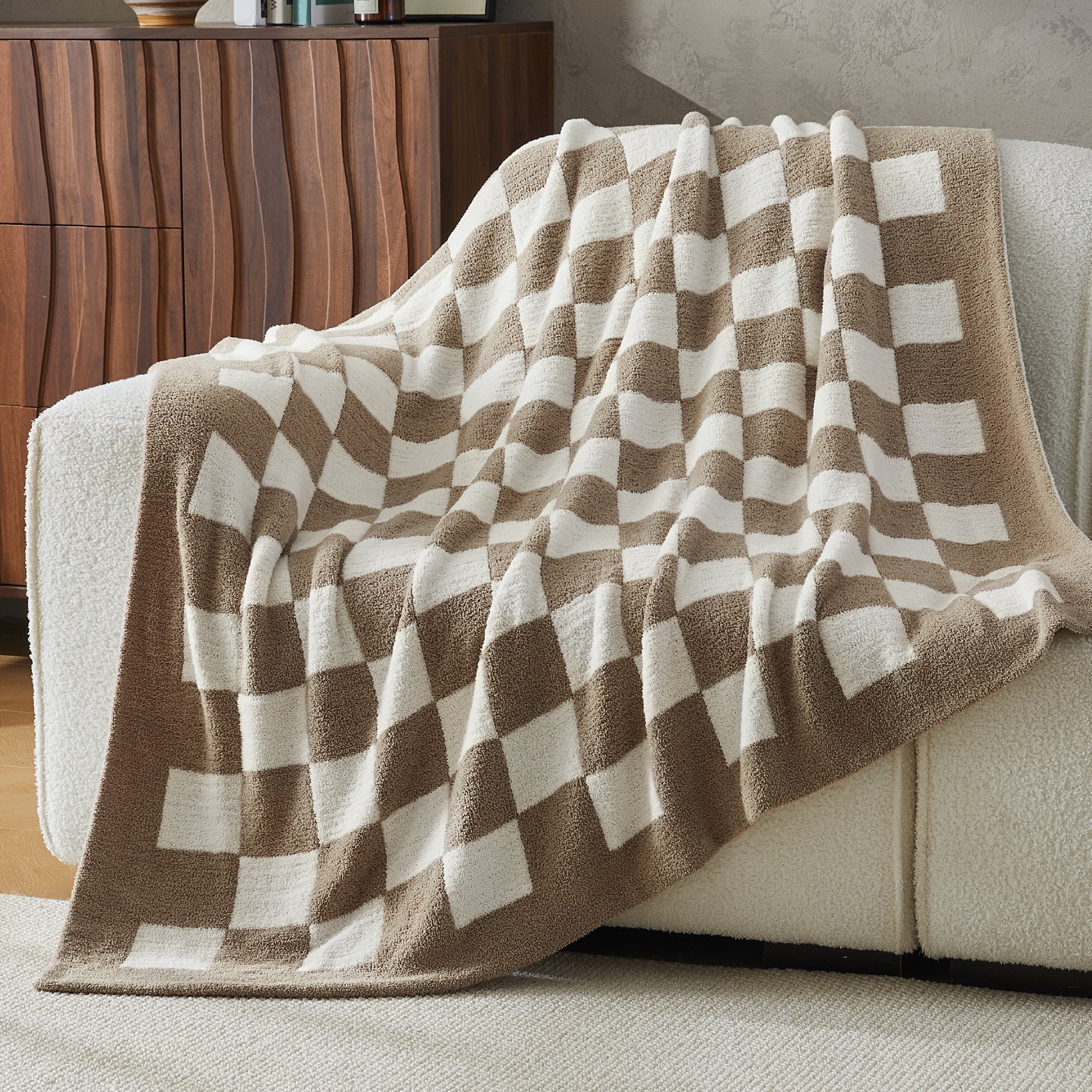 Litanika soft knit checkered throw blanket draped over a bed, cozy bedding accessory with a classic pattern and soft texture.