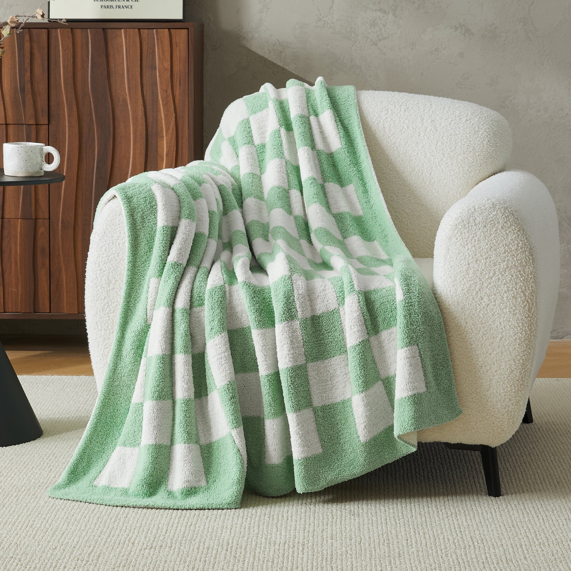 Litanika soft knit checkered throw blanket draped over a bed, showcasing its cozy, lightweight bedding for relaxing comfort.