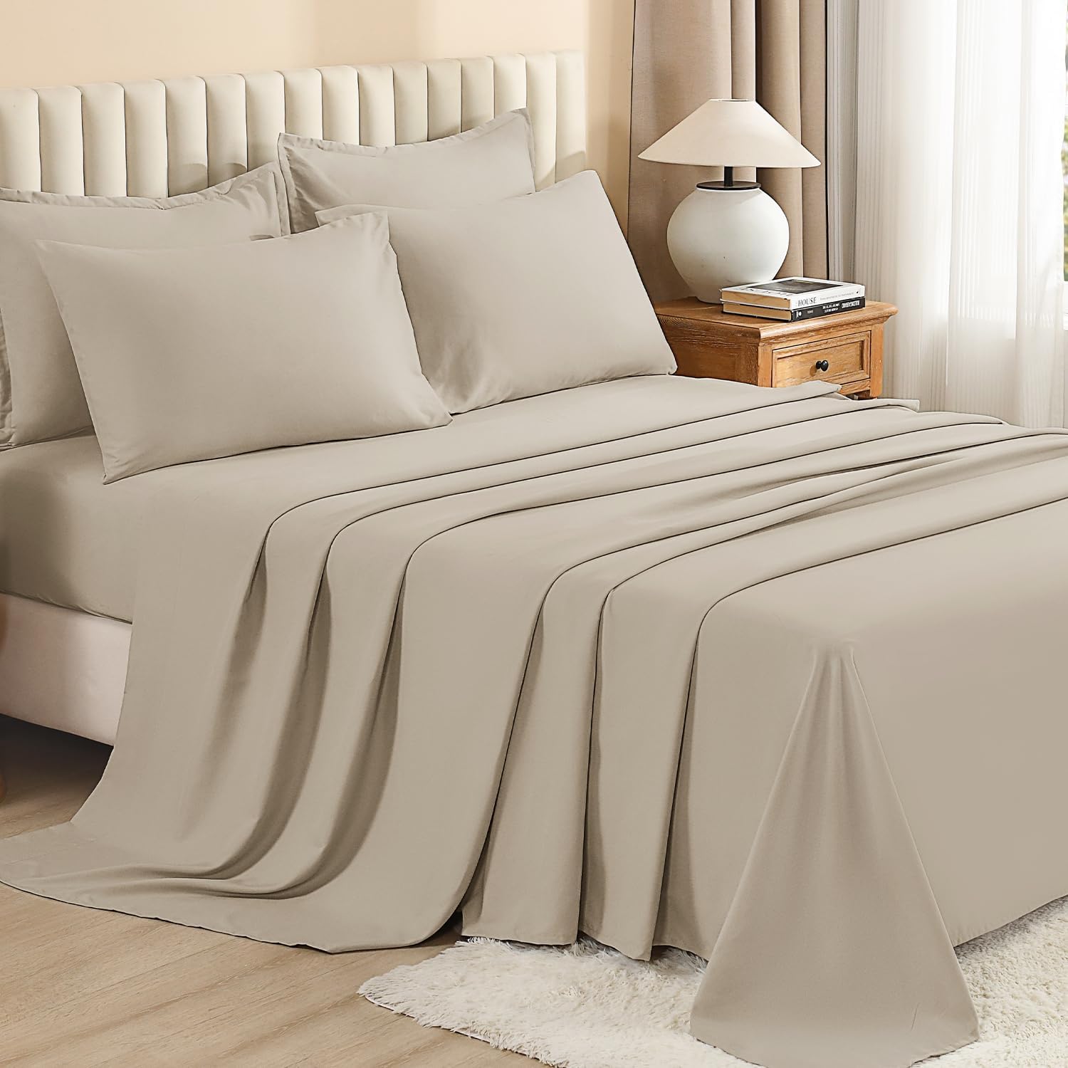 Litanika solid down 7-piece comforter bedding set with matching pillow shams on a neatly made bed.
