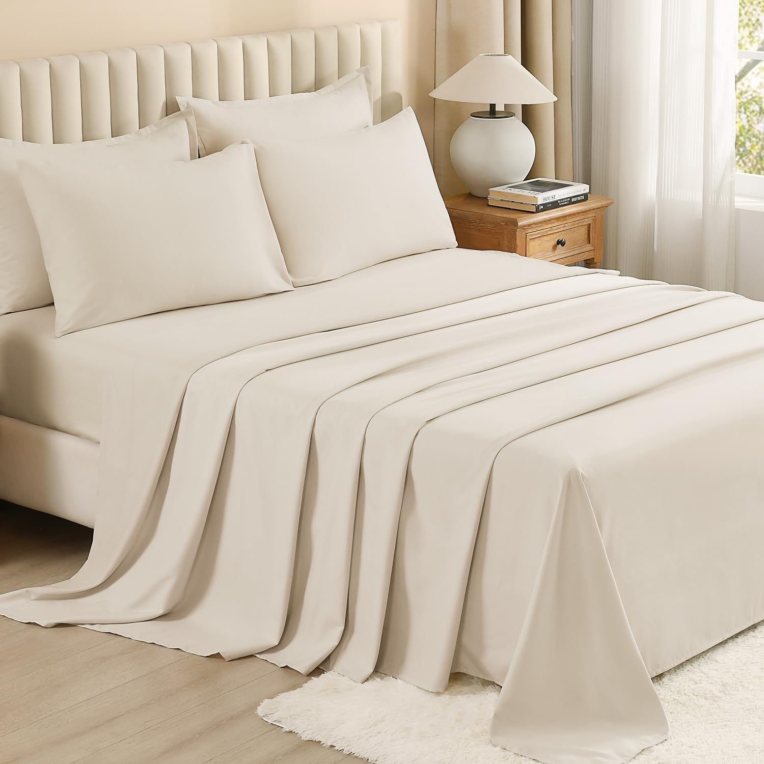 Litanika solid down 7-piece comforter bedding set with matching pillows and sheets in a cozy, neutral color.