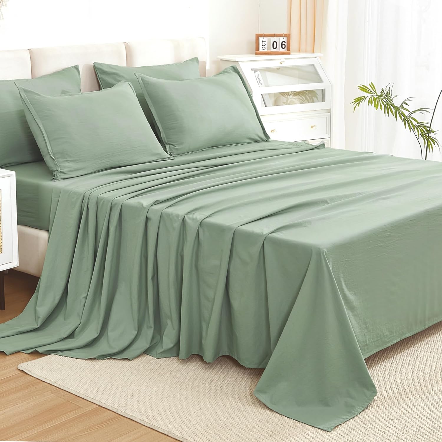 Litanika solid down sage green twin size 7-piece bedding comforter set with matching pillows and sheets.