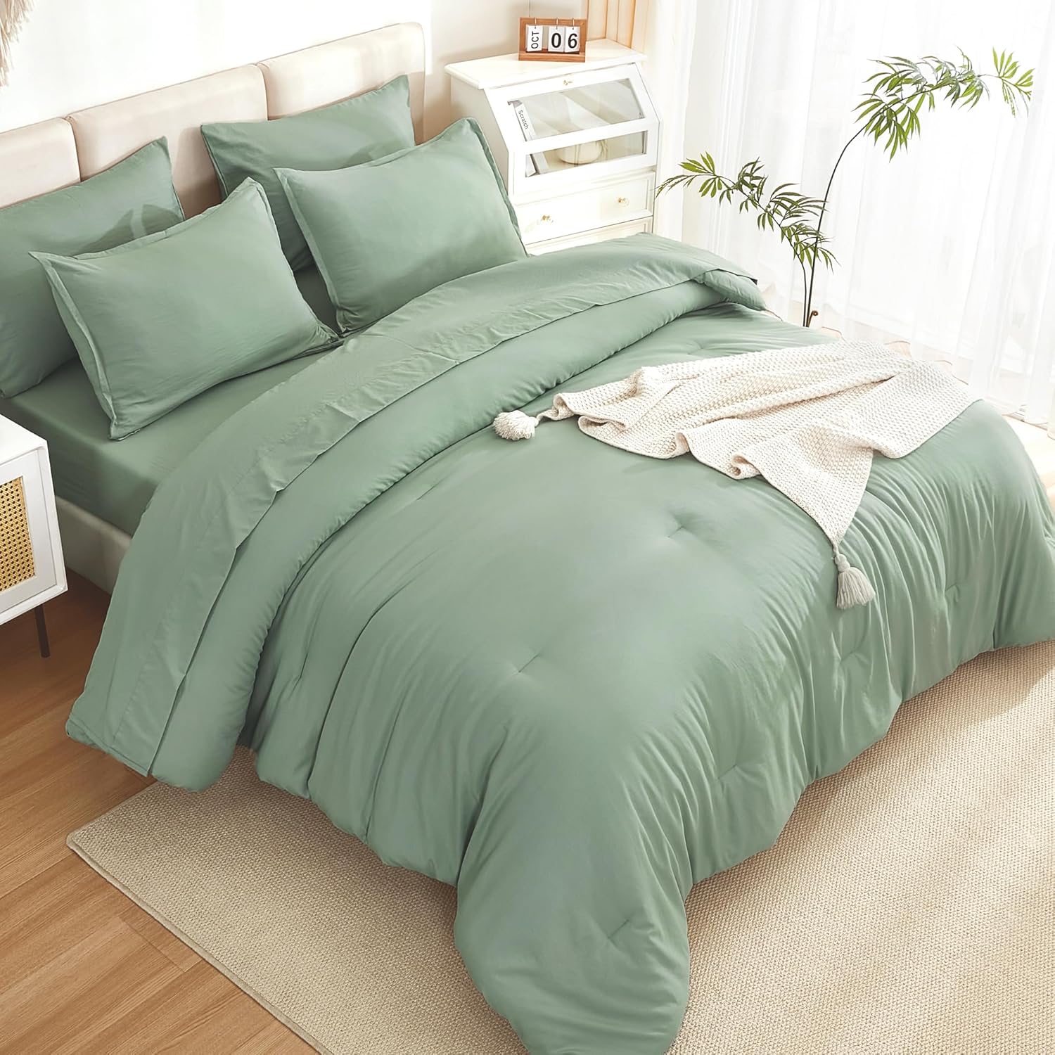 Litanika solid sage green twin size 7-piece down comforter bedding set with matching pillow shams and sheets.