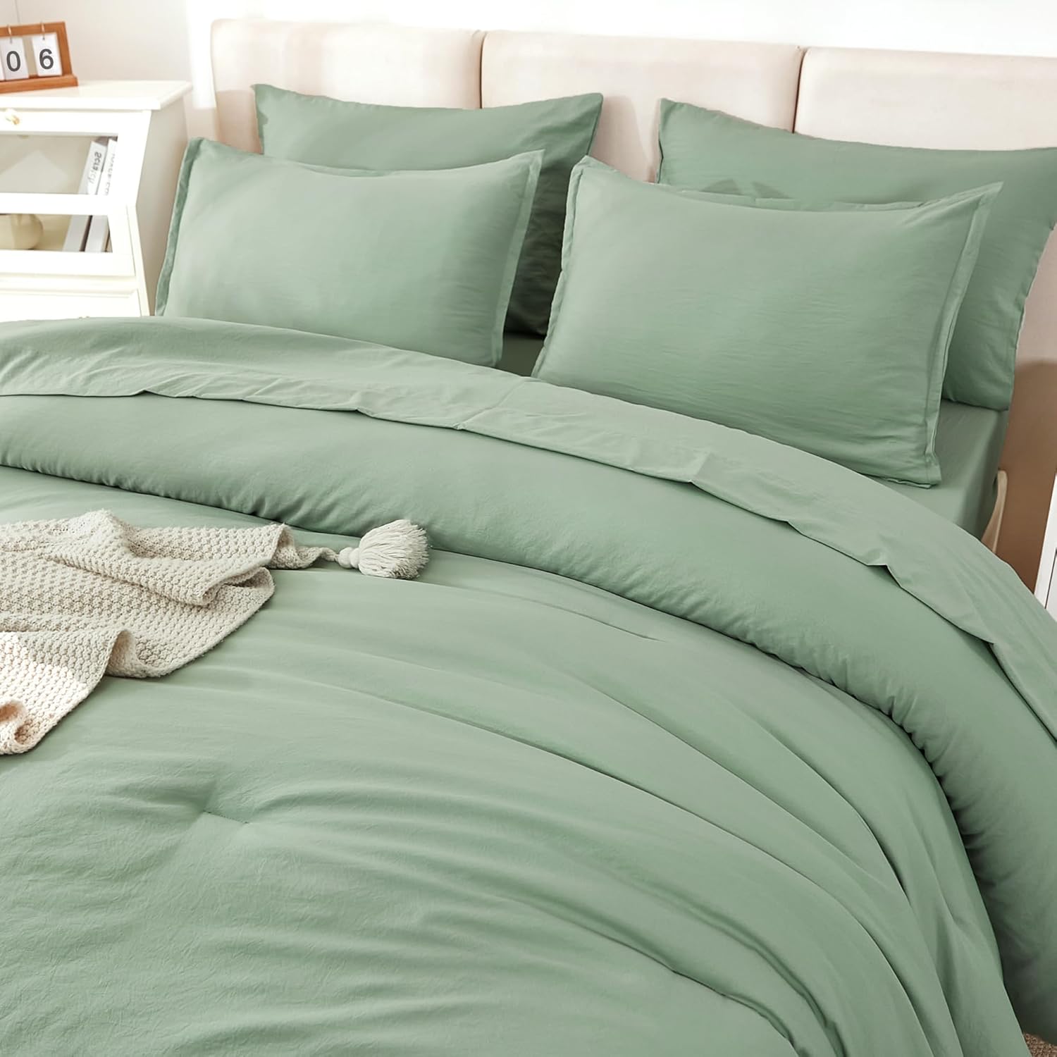 Solid sage green twin size bedding set by Litanika with 7 pieces including comforter, pillow shams, and sheets.